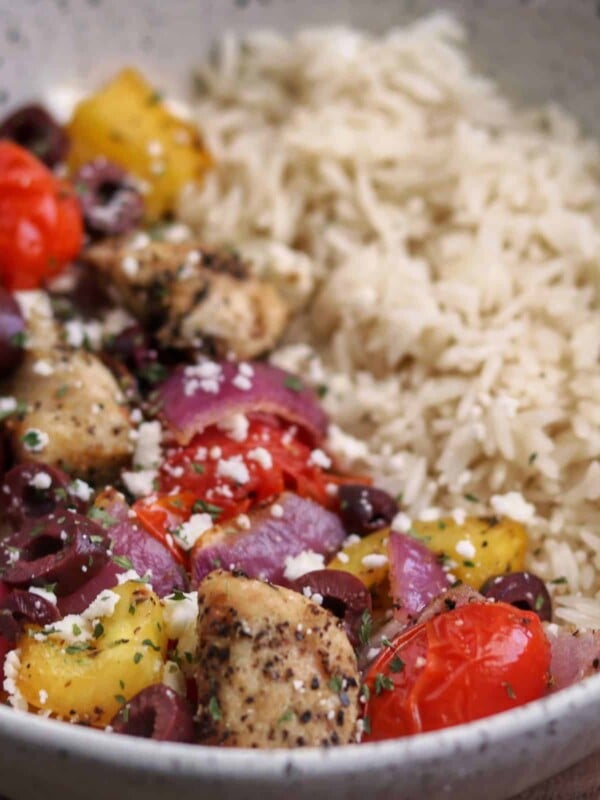 Greek chicken breast and veggies in a bowl with rice