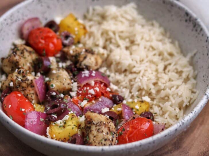 Greek chicken breast and veggies in a bowl with rice