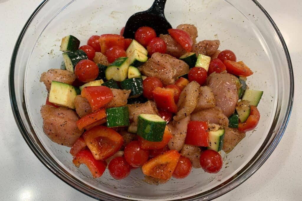chicken breast, zucchini, bell pepper, and grape tomatoes with cajun seasoning and olive oil