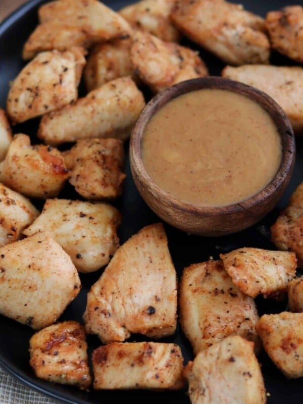 Chick-Fil-A grilled nuggets copycat on a black plate with honey bbq dipping sauce