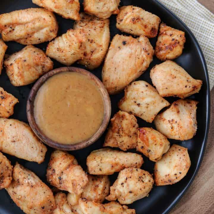air fried nuggets on a plate with a small cup of honey bbq dipping sauce