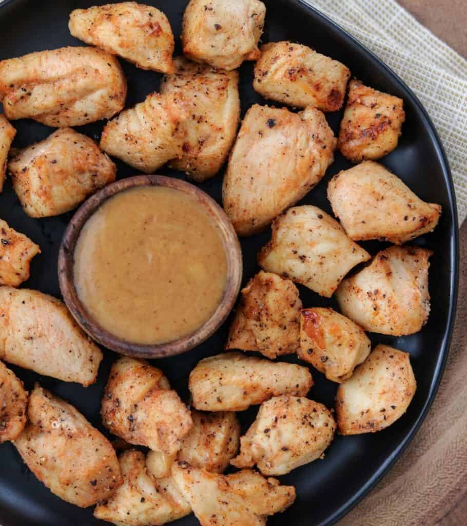 air fried nuggets on a plate with a small cup of honey bbq dipping sauce