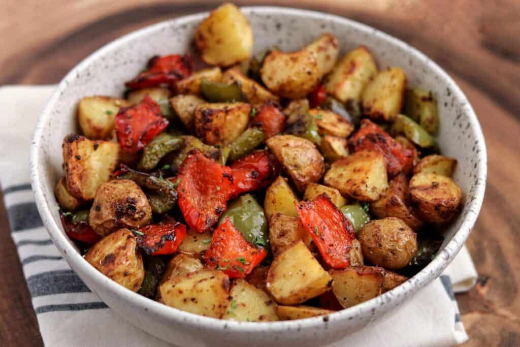 air fried breakfast potatoes with bell pepper in a white bowl