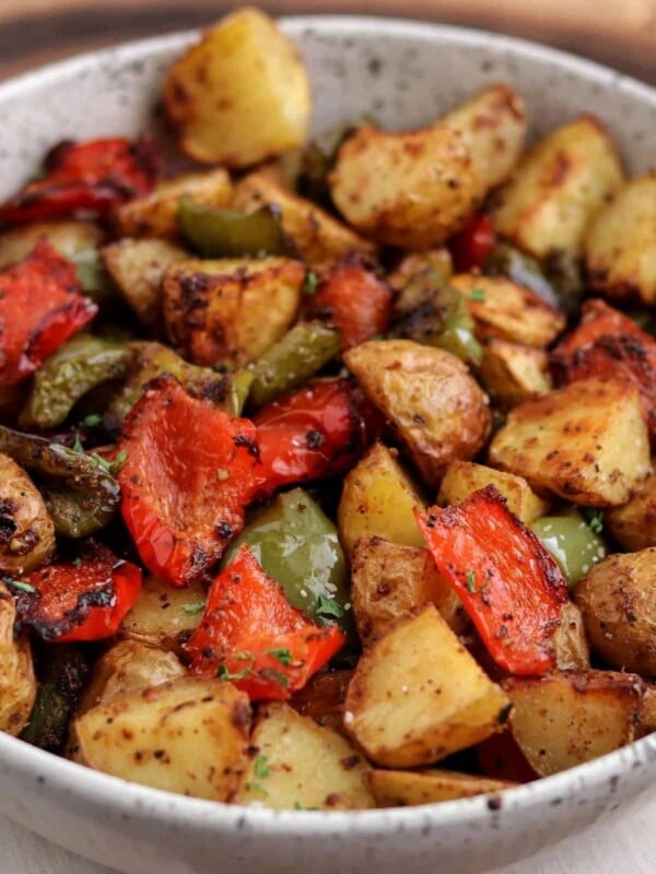 air fried breakfast potatoes with bell pepper in a white bowl