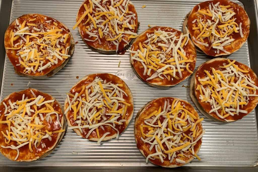 pizzas with cheese before baking