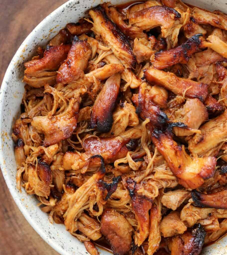 crispy pulled BBQ chicken thighs in a bowl