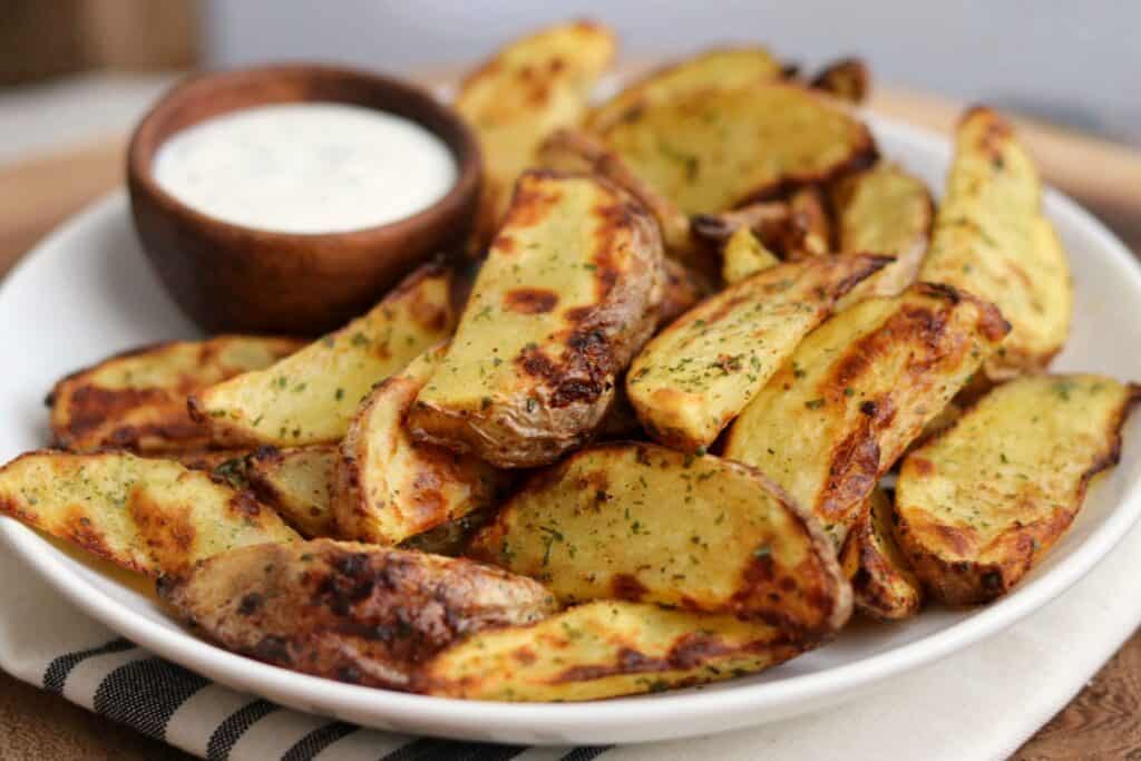 ranch potato wedges in a bowl with ranch dip