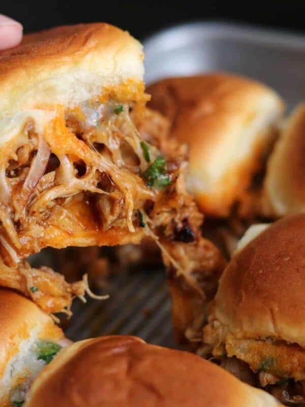one of the chicken sliders being pulled from the pan