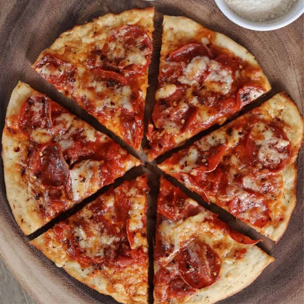 sliced cast iron pizza made with Greek yogurt pizza dough