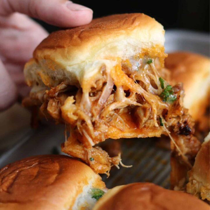 pulling a BBQ chicken slider out of the pan