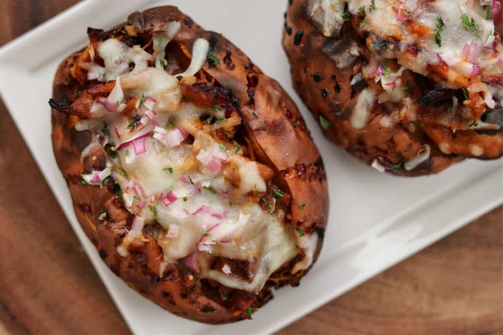 pulled bbq chicken stuffed sweet potato on a plate