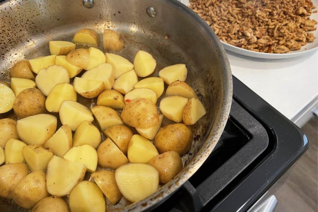 quartered baby gold potatoes in a sauté pan