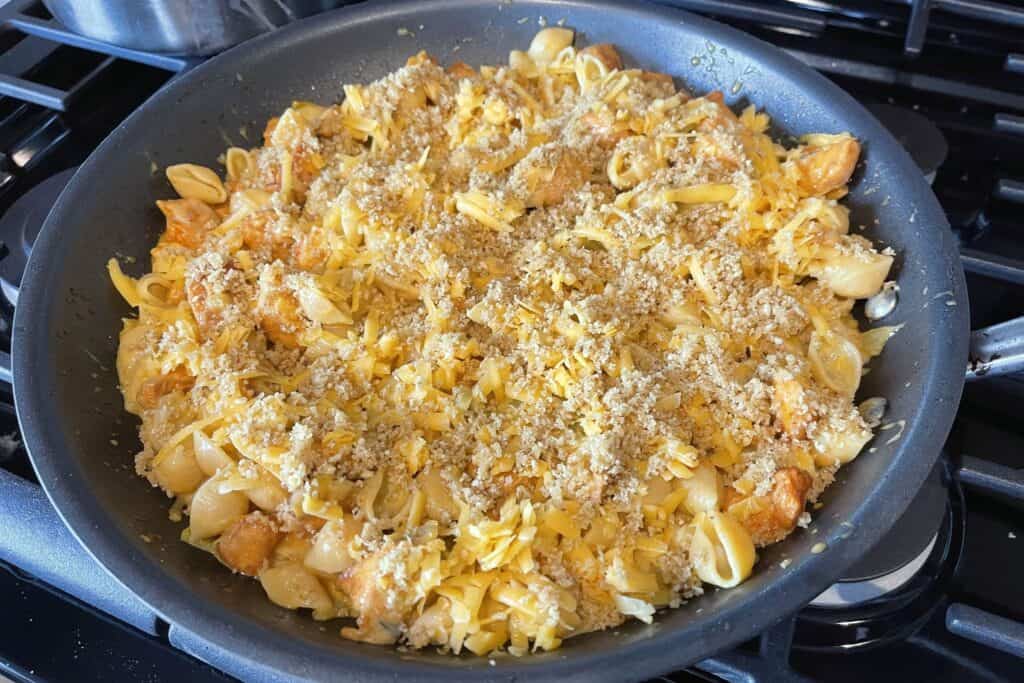breadcrumbs and shredded cheddar on top of the green chile mac and cheese