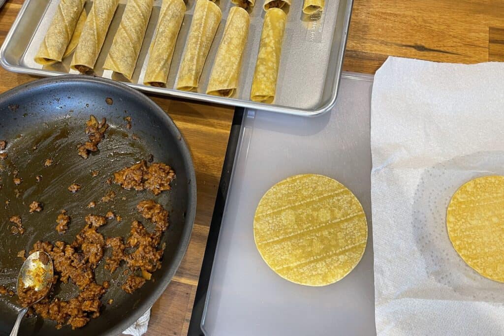 filling and rolling the beef taquitos