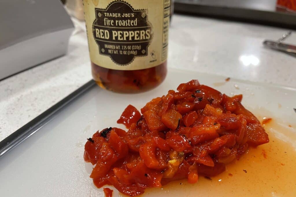 pickled roasted red peppers diced on a cutting board