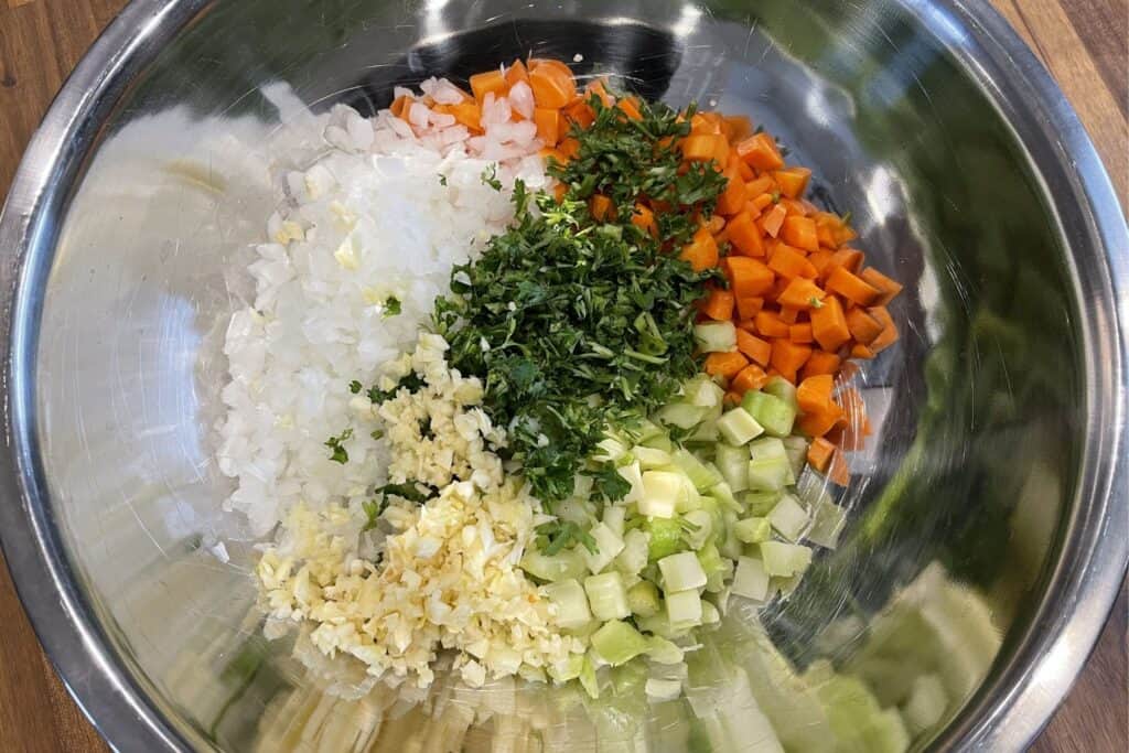 diced onion, celery, and carrots with parsley and minced garlic