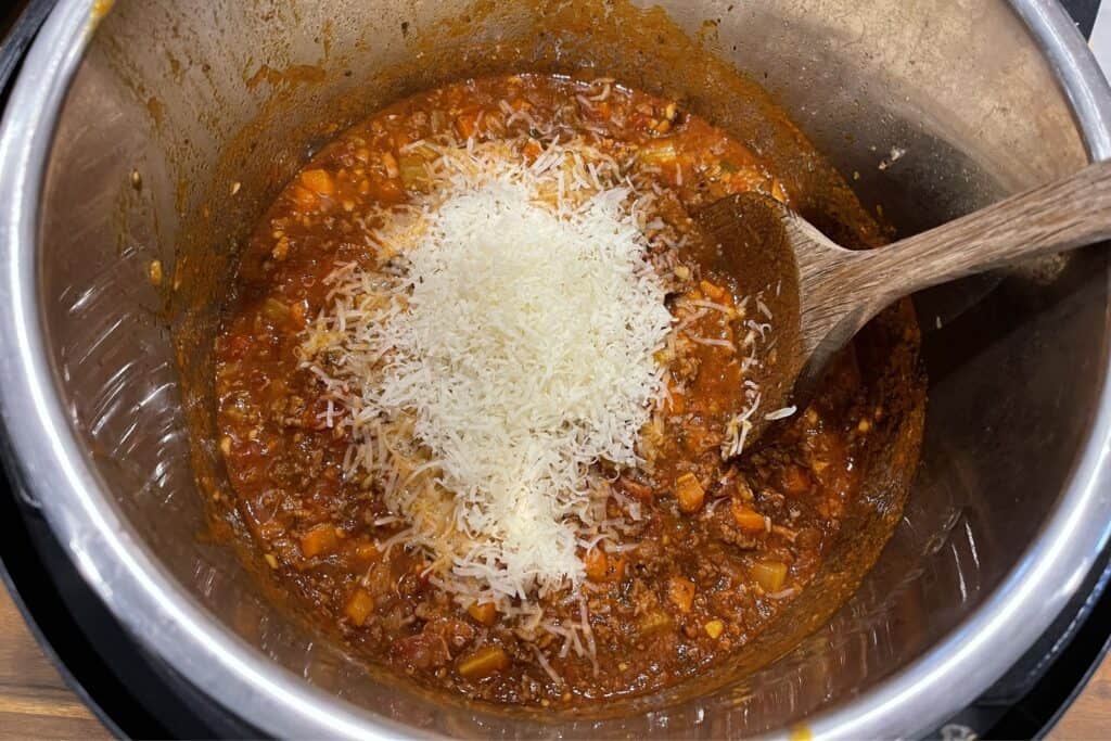 grated parmesan and the finished bolognese