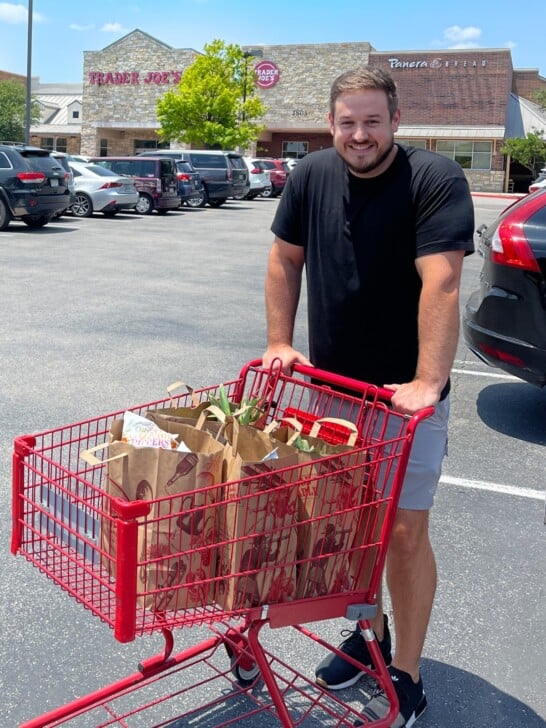 mason woodruff standing in front of a Trader Joe's pushing a shopping cart