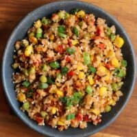 fried cauliflower rice with green onion and sesame seeds in a bowl