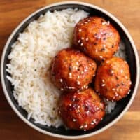 bbq chicken meatballs in a black bowl with white rice