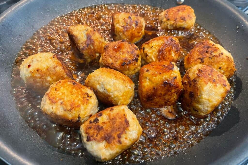 sauce added to the pan with cooked meatballs