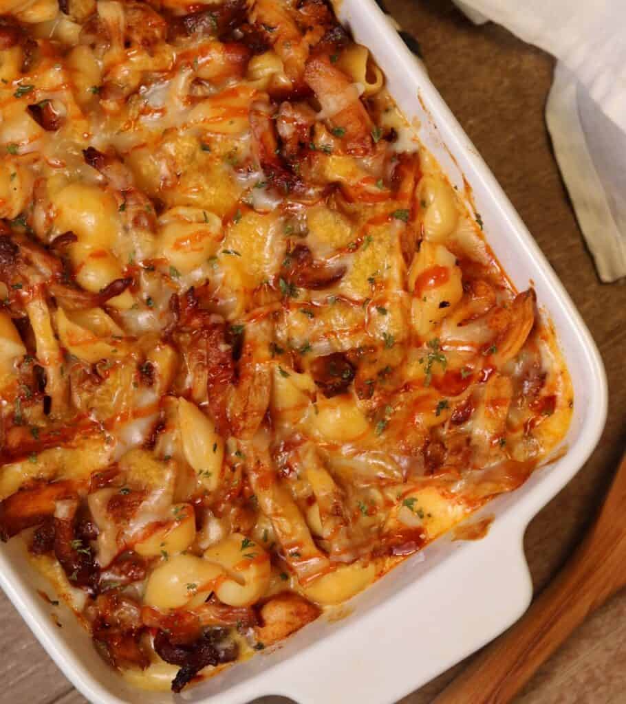 a baking dish with bbq chicken mac and cheese