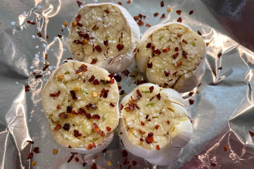 garlic bulbs in foil with olive oil, salt, and red pepper flakes