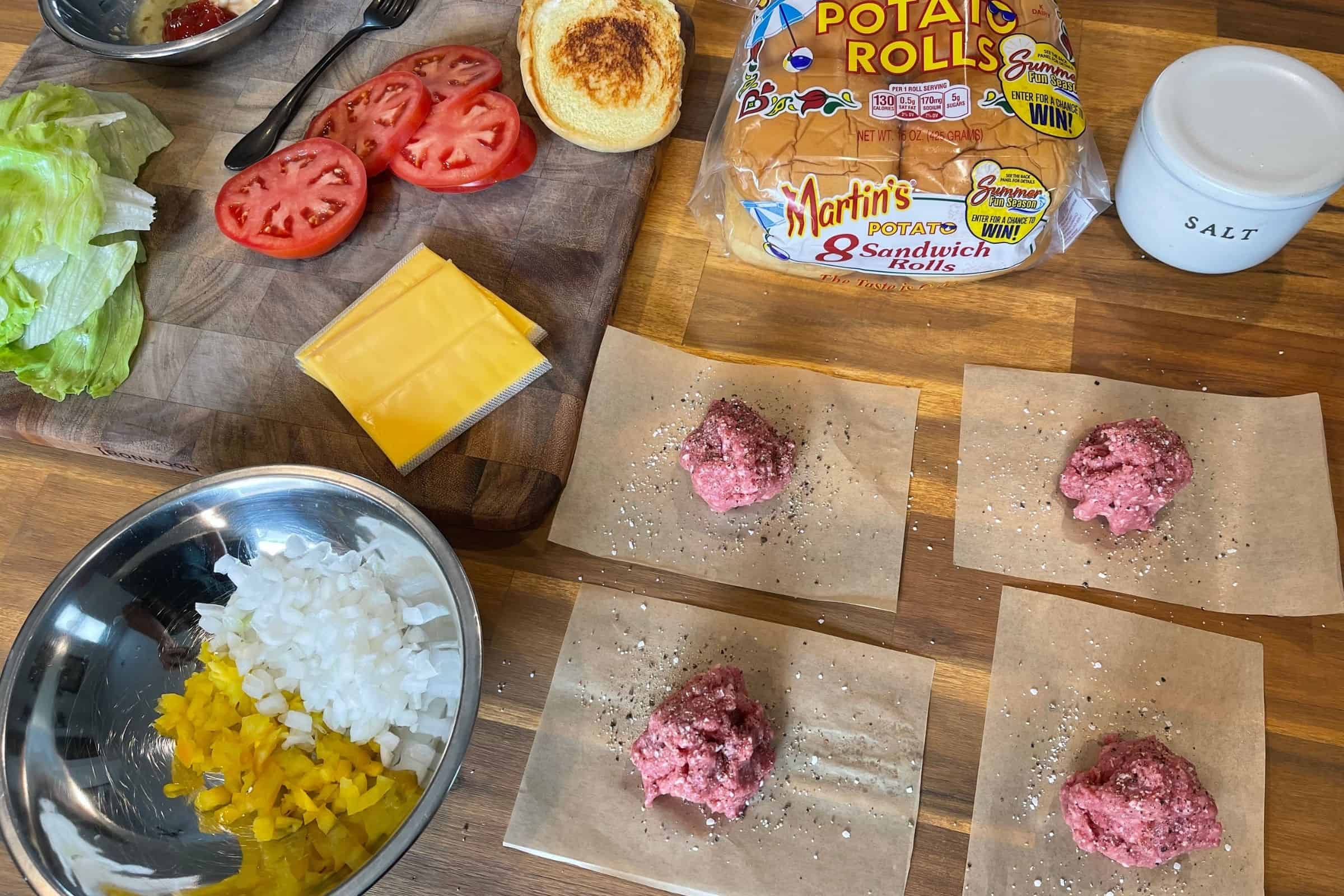 chopped banana peppers, diced onion, and yellow mustard on burger patty before flipping