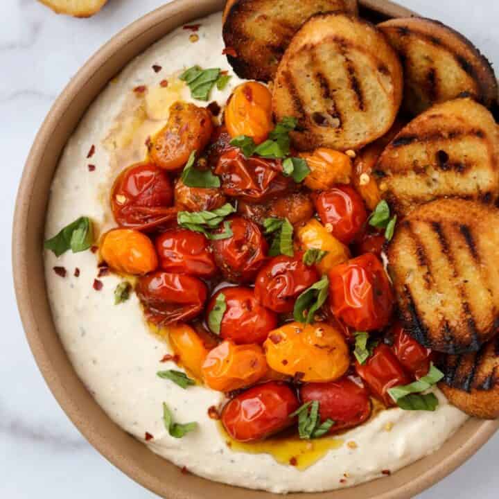 a bowl of creamy feta dip and roasted tomatoes
