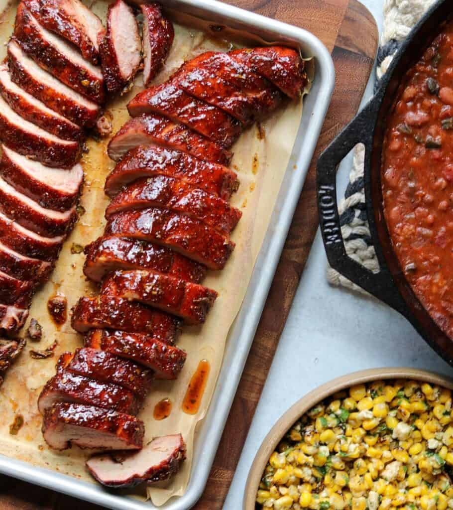 slices of smoked pork tenderloin with charro beans and corn salad