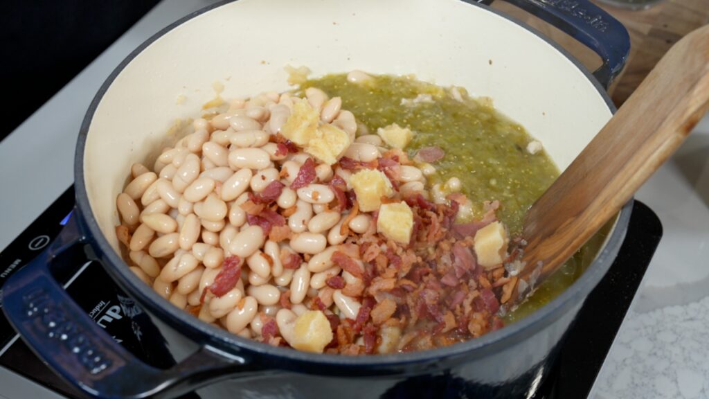 white kidney beans, crispy bacon, minced garlic, and salsa verde added to a Dutch oven with cooked ground chicken and onion