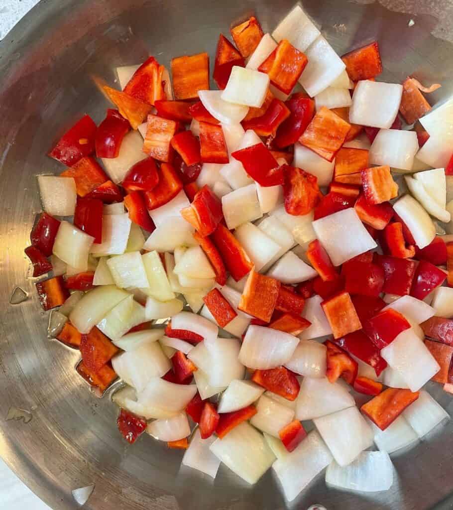 diced onion and bell pepper in a skillet with olive oil