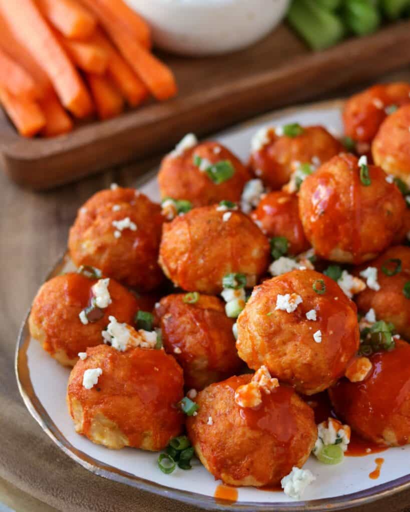smoked buffalo chicken meatballs topped with green onion and gorgonzola cheese