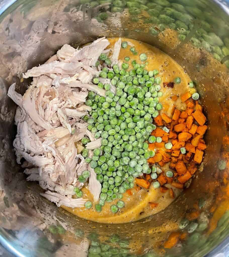 pulled rotisserie chicken, frozen peas, and roasted carrots added to the cauliflower soup
