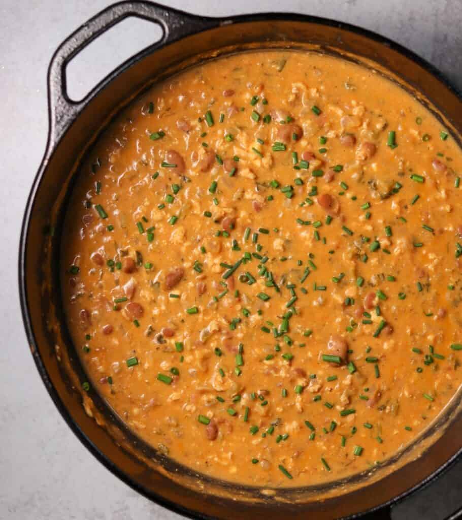 cast iron Dutch oven filled with buffalo chicken chili topped with chives