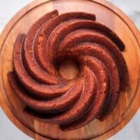 chocolate banana swirl protein powder cake on a wooden cake stand