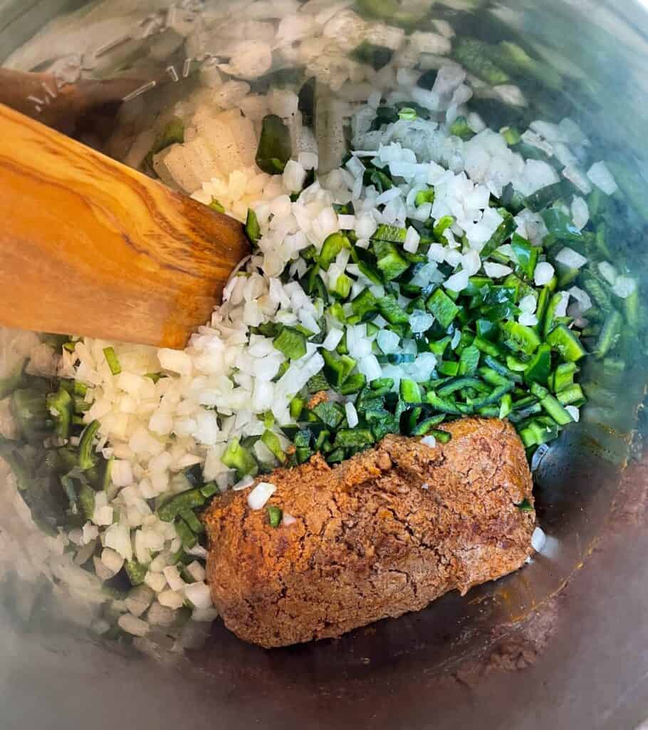 ground chorizo in the Instant Pot with diced onion and poblano peppers