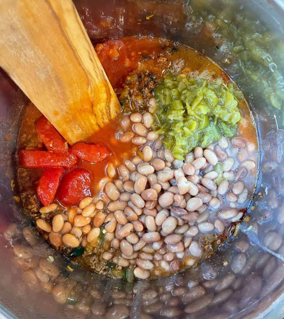 canned pinto beans, stewed tomatoes, and diced green chiles added to the cooked chorizo and vegetables