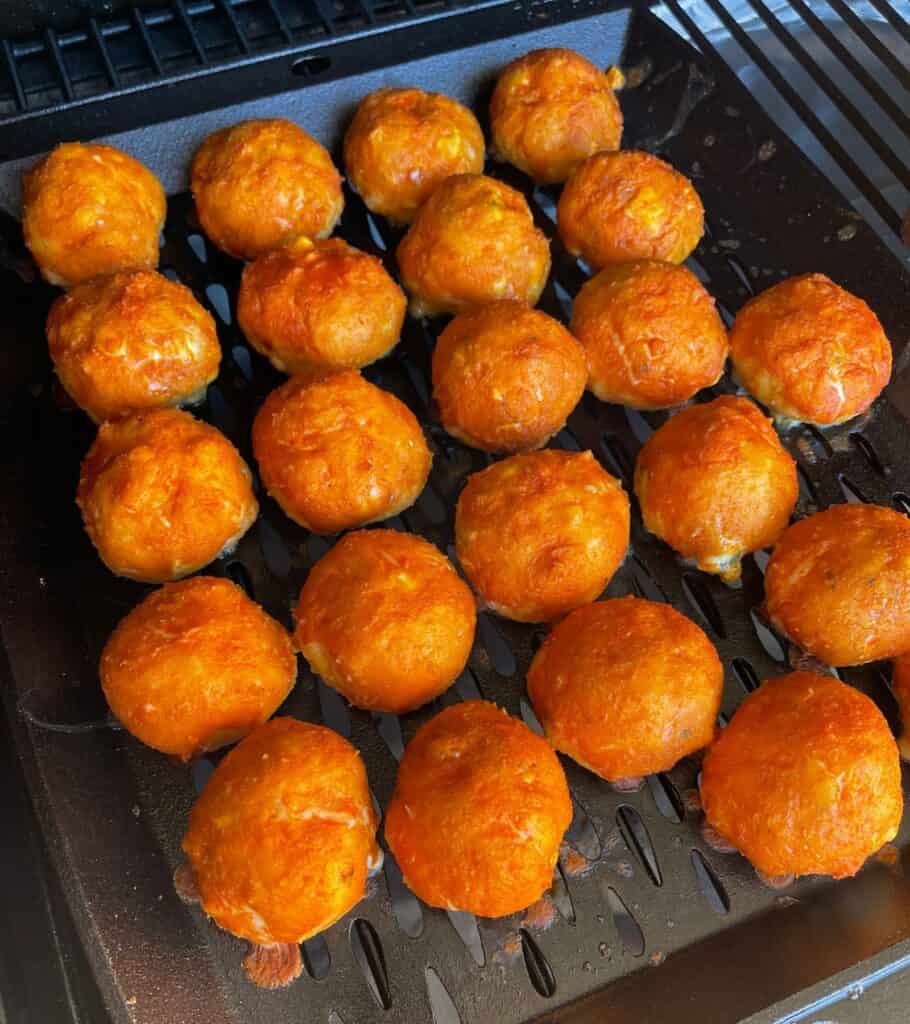 smoked buffalo meatballs on a cast iron grill pan in the Traeger