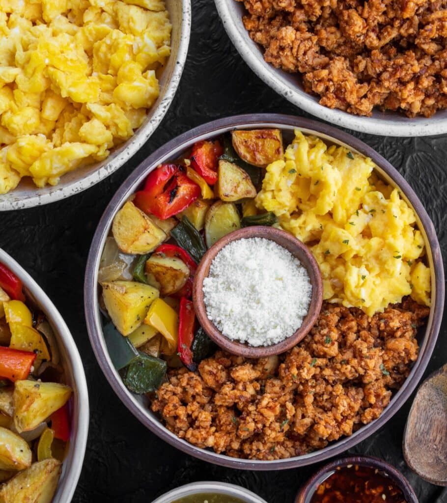 breakfast bowls with ground chicken, scrambled eggs, and roasted vegetables