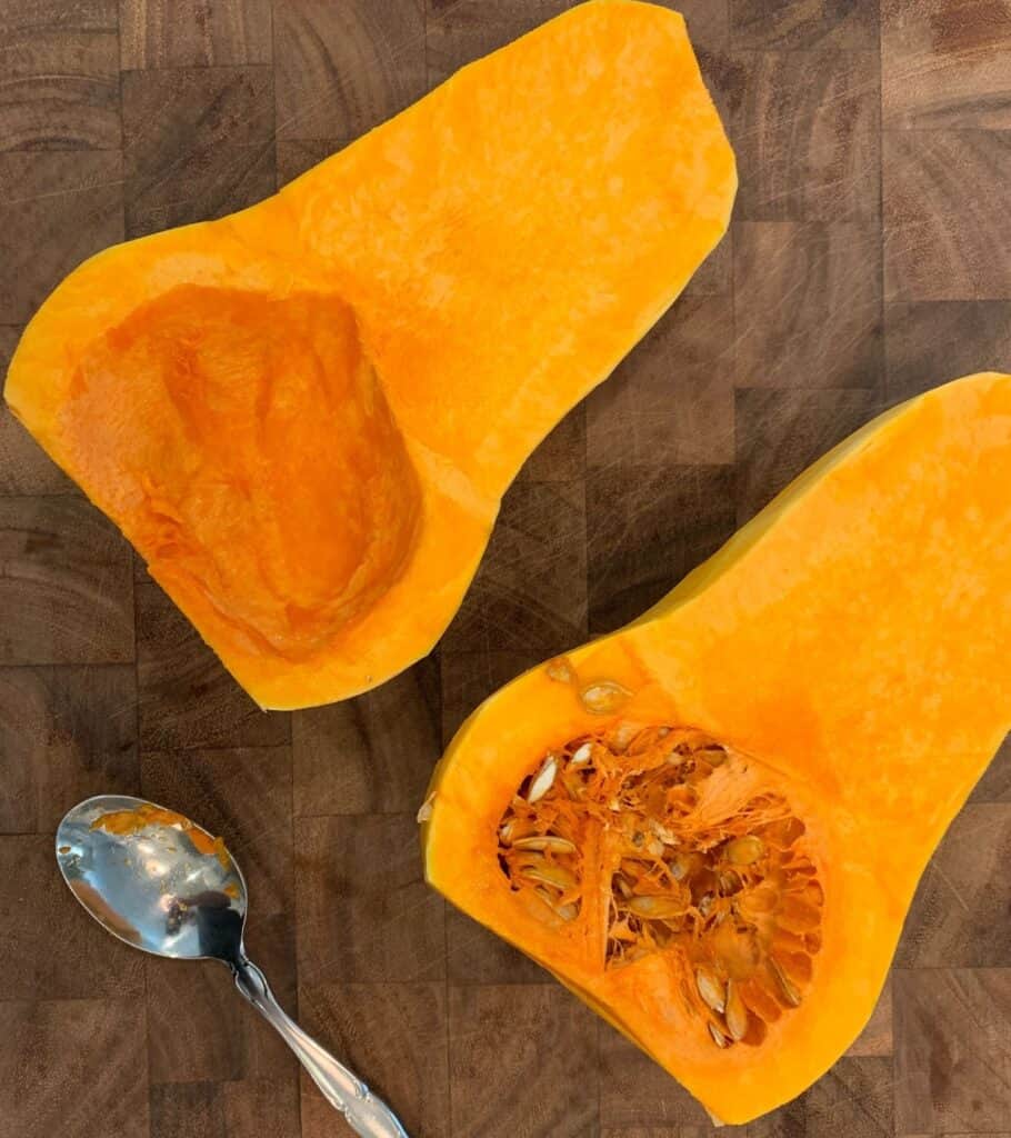 halved butternut squash with the seeds scooped out of one side