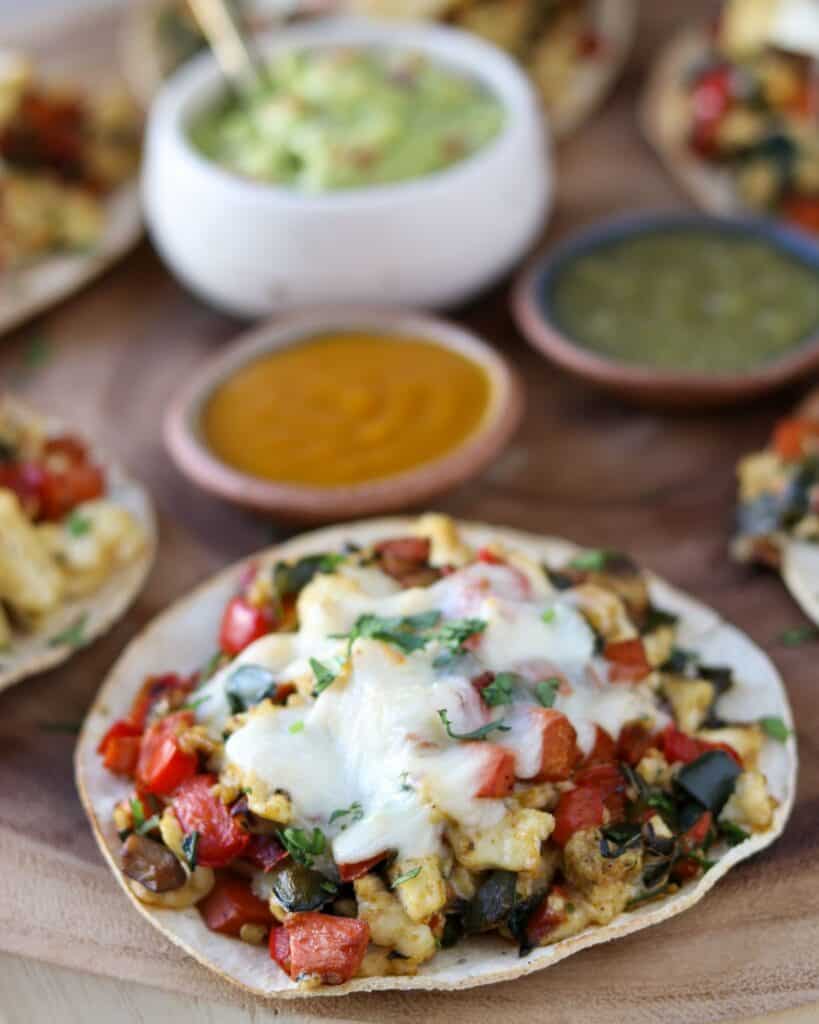baked breakfast tostada with melted cheese and chopped cilantro