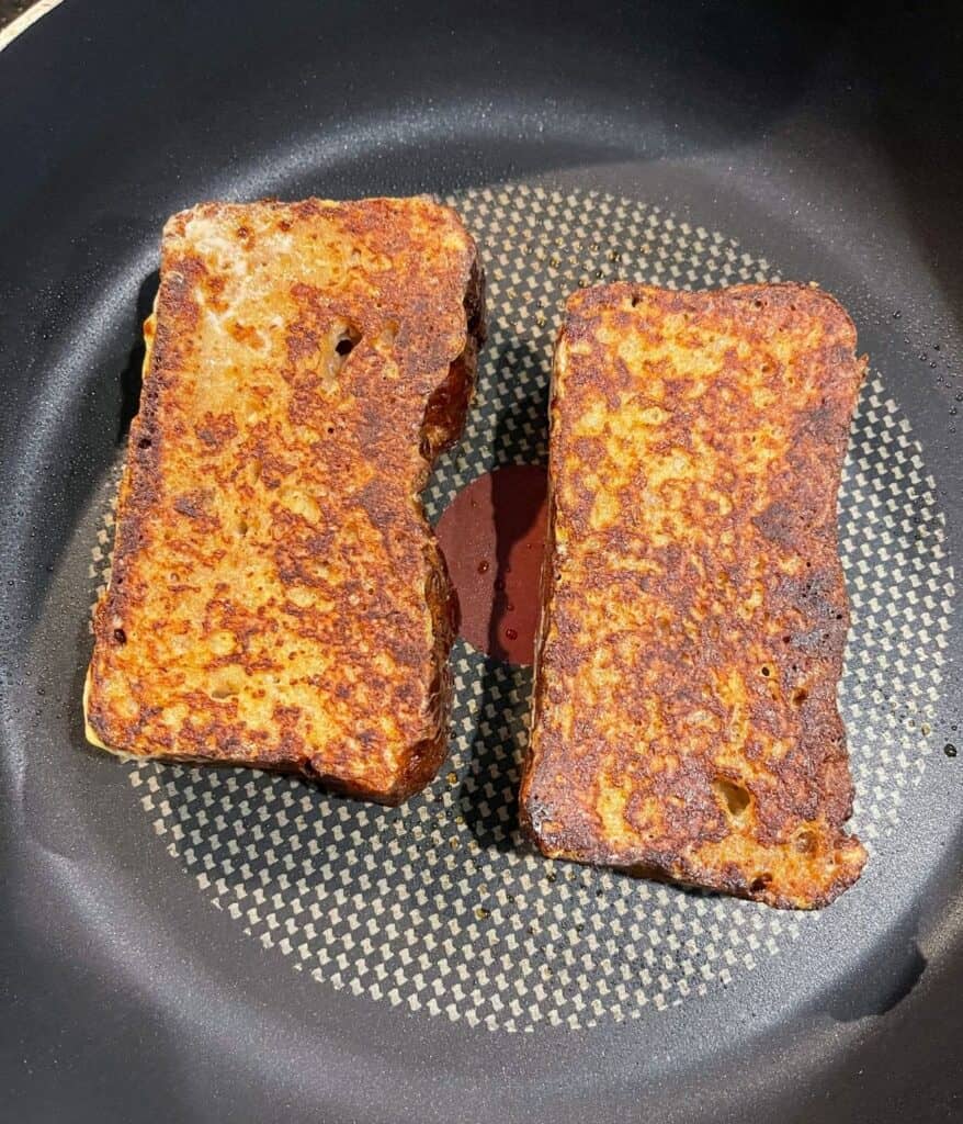 two slices of protein French toast frying a skillet