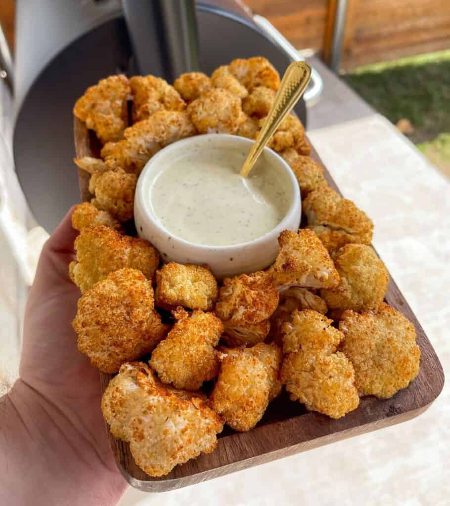 Traeger smoked cauliflower on a plate with dipping sauce