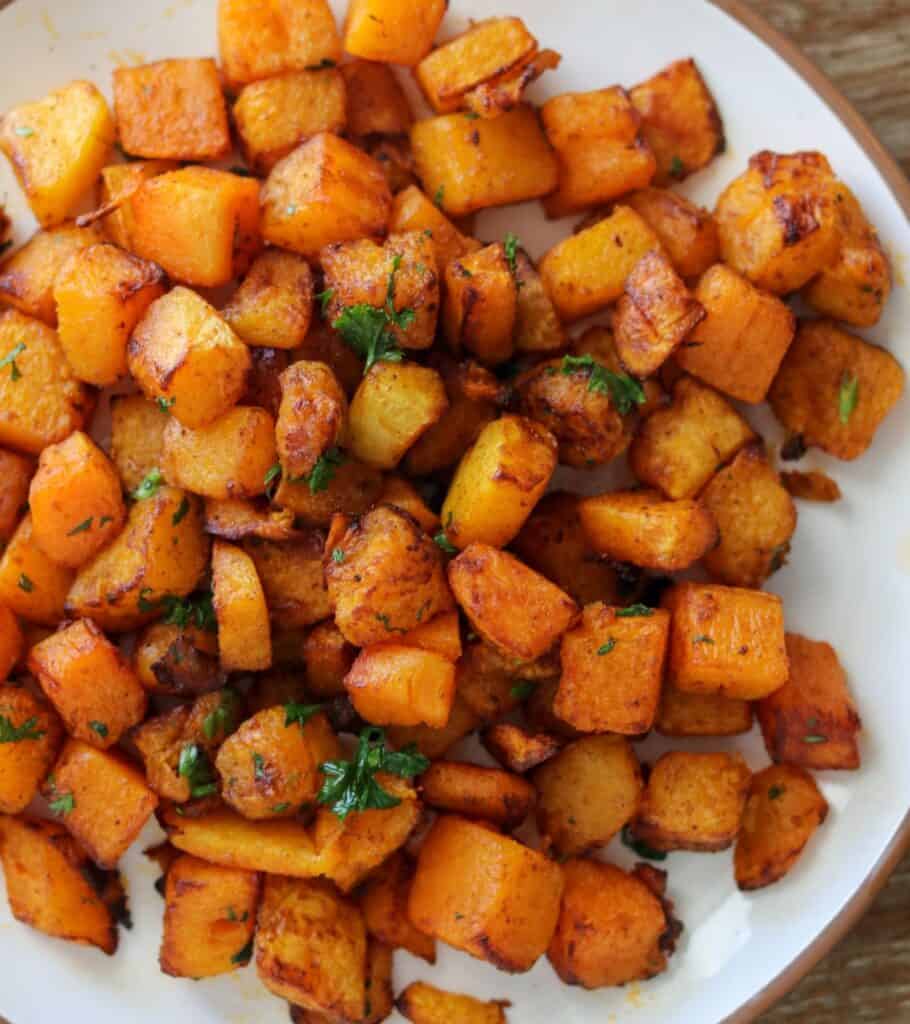 smoked paprika butternut squash on a plate with fresh parsley