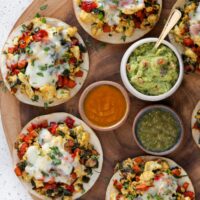 baked tostadas topped with egg whites, veggies, and cheese