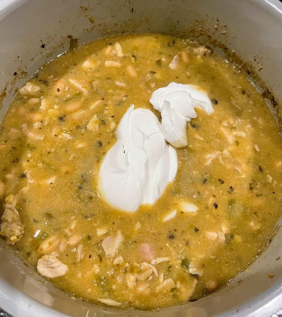 cream cheese on top of the chicken stew in the slow cooker