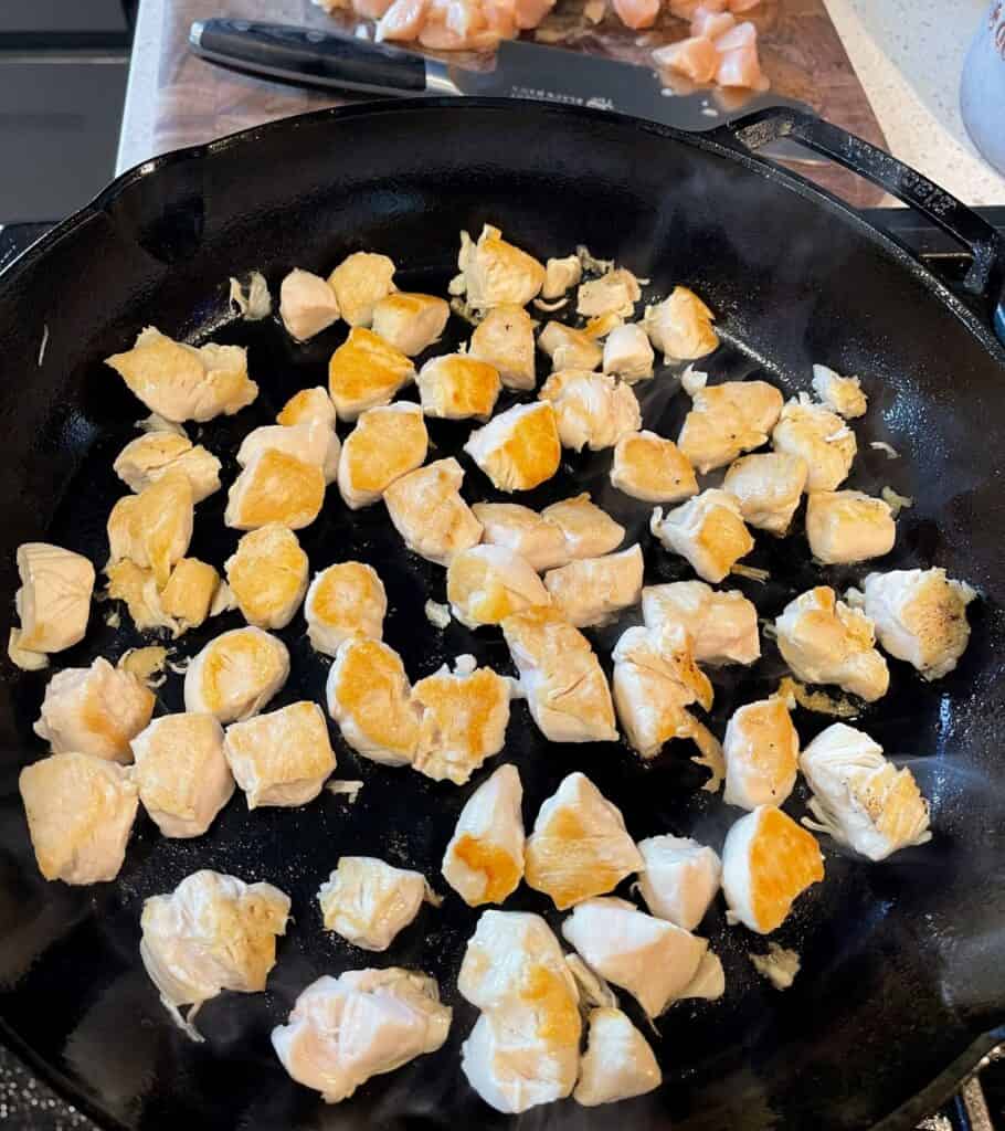 cooking chicken bites in a cast iron skillet