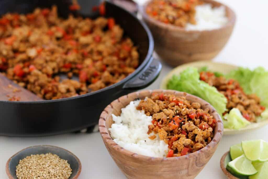 chili garlic ground pork in bowls with rice and lettuce wraps