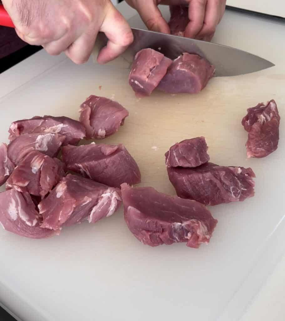 slicing pork tenderloin into pieces